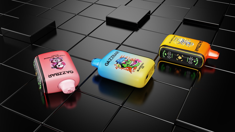 Three brightly colored vape devices with bold, graphic illustrations and the brand name "GAZZBAR" lie on a glossy black, tiled surface.