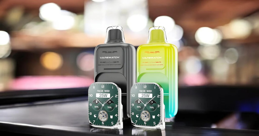 Jnr Vapewatch 30K Puffs - The Ultimate Swype Vape Phone With Screen &Amp; App 12 Two Vape Devices Labeled &Quot;Vapewatch&Quot; With Digital Watch-Style Displays Showing Time, Date, And Wattage Setting, Placed On A Blurred Background.