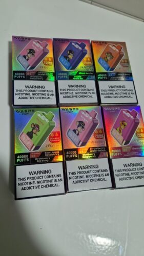 Boxes of vaping devices labeled "WASPE FiiHP" with colorful packaging featuring cartoon monkeys, flavor names, and nicotine warning text.